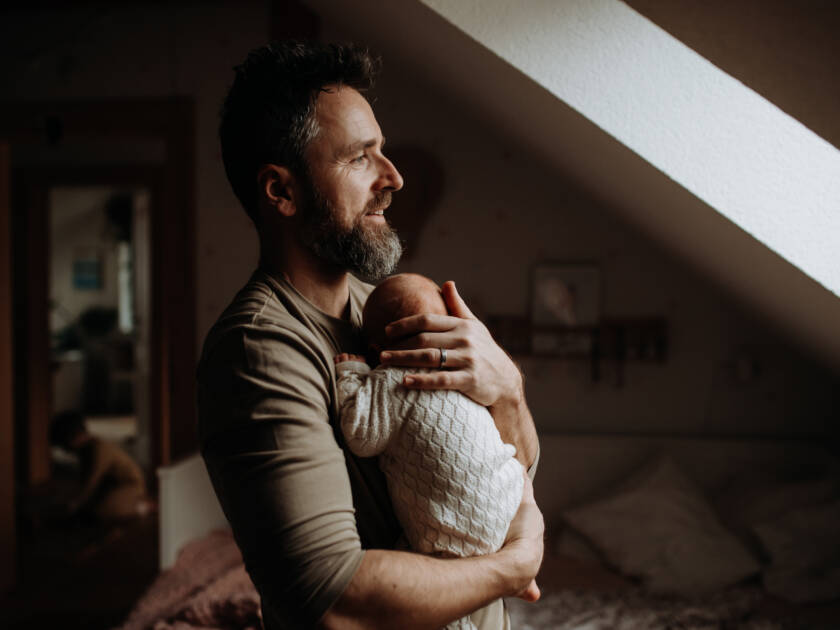 Father holding his newborn baby.