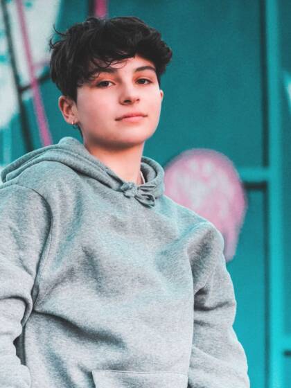 A young boy is looking into the camera.