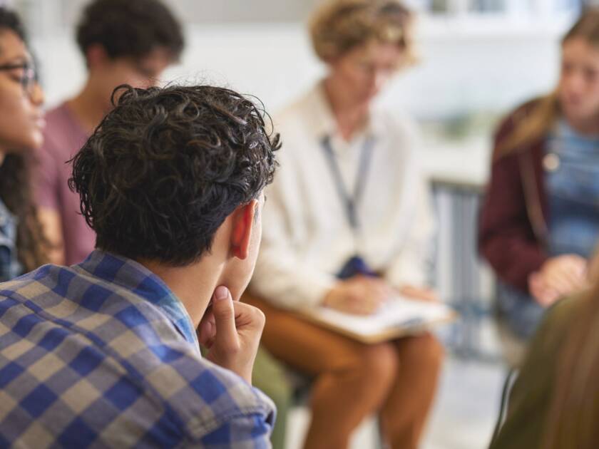 Several people are sitting in a circle discussing.