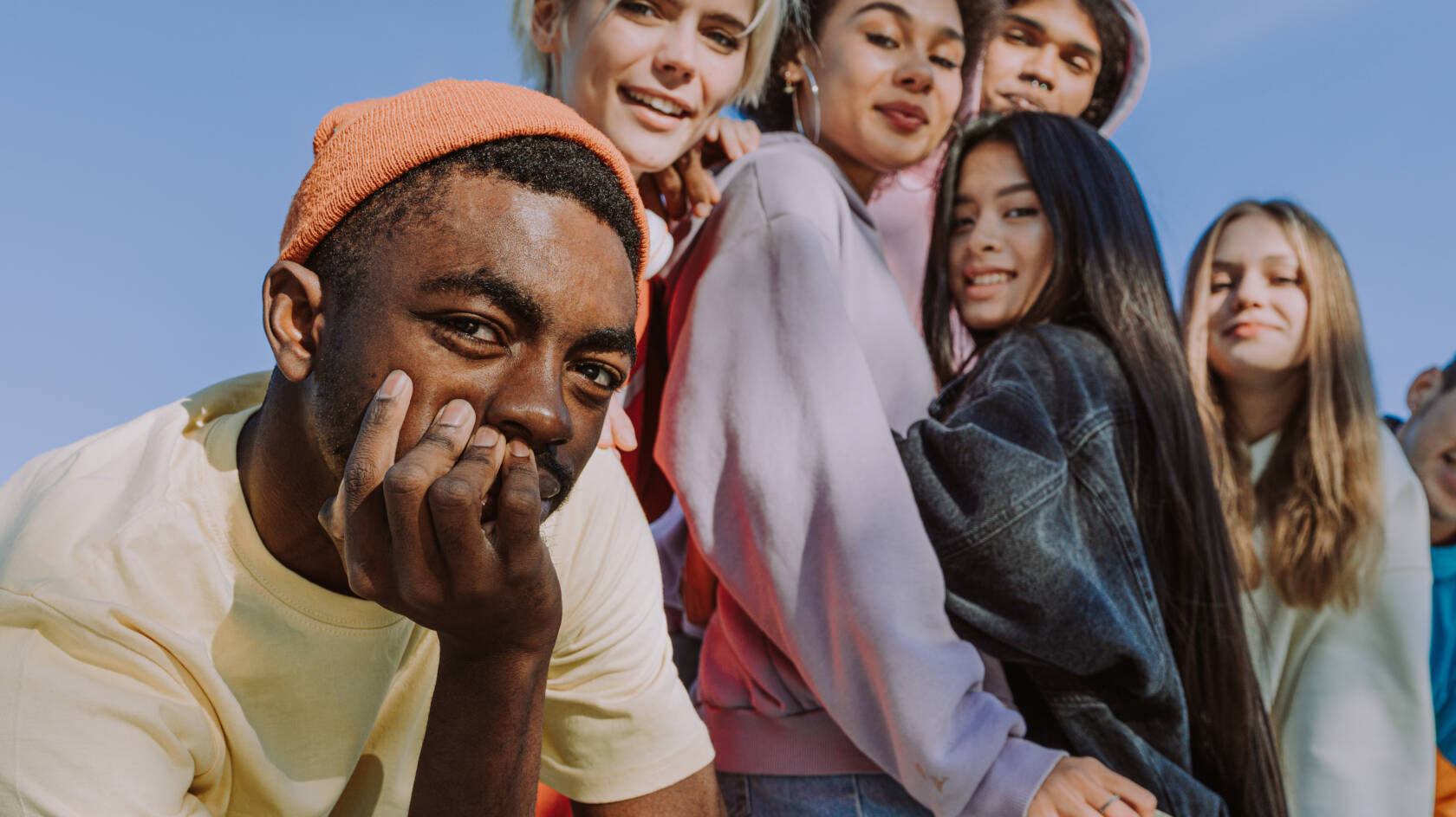 Multiracial group of young friends bonding outdoors