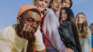 Multiracial group of young friends bonding outdoors