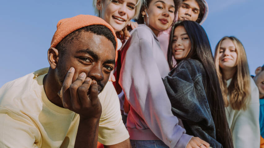 Multiracial group of young friends bonding outdoors