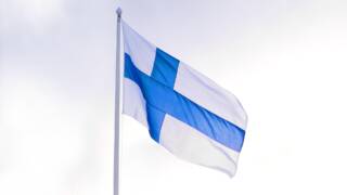 Suomen lippu liehuu lipputangossa.