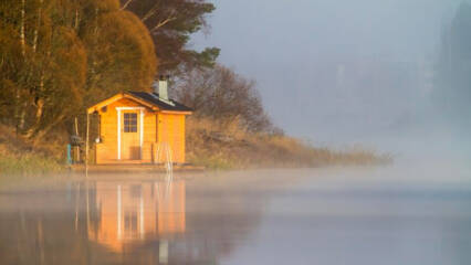 Sauna rakennus rannalla, järvellä usvaa.